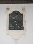 Dark wall plaque with a fairly simple white marble surround